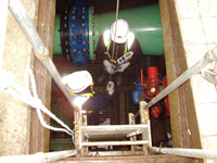 JRP personnel working in a confined space with full PPE
